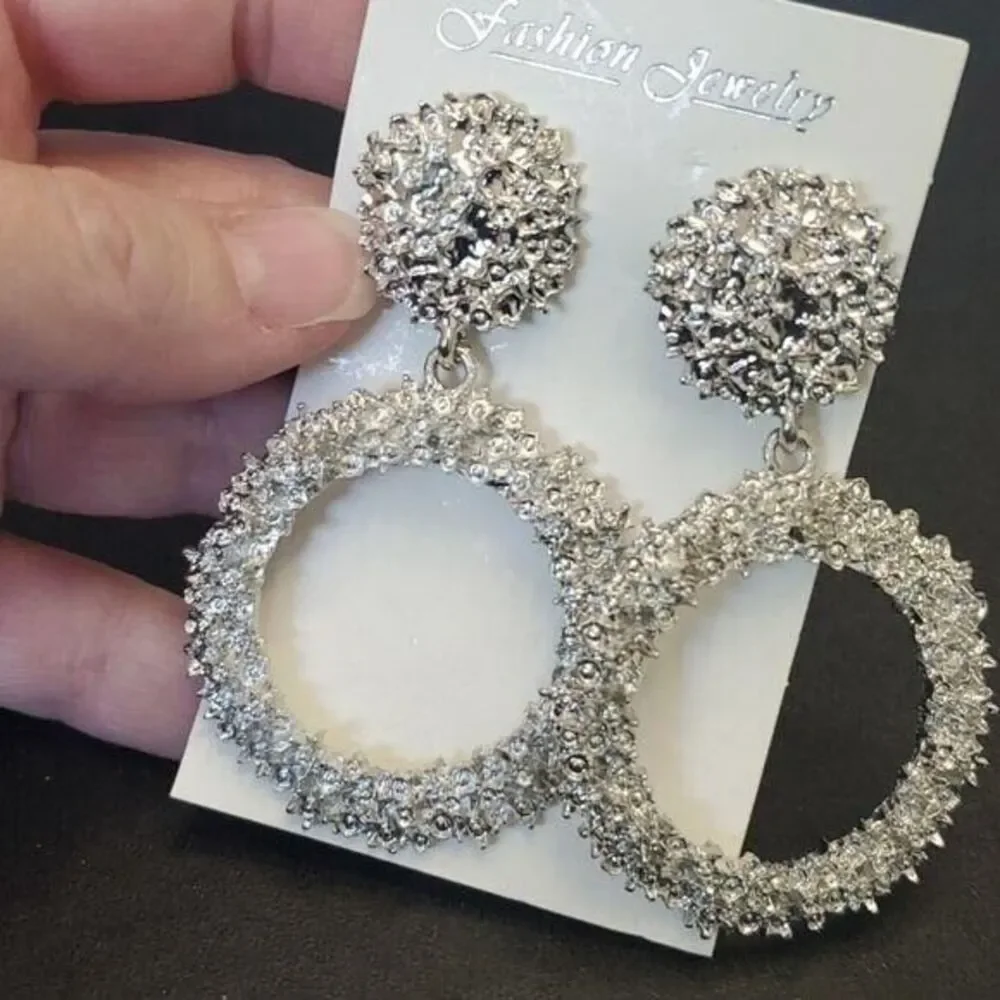 Silver tone circular themed statement earrings texture chunky